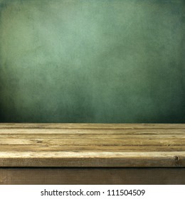 Wooden Deck Table On Green Grunge Background