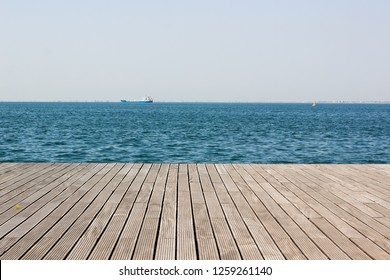 wooden deck waterfront sea shoreline background texture and water surface with small waves with horizon line, wallpaper pattern, copy space - Powered by Shutterstock