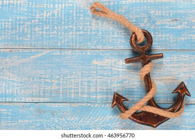 Wooden decorative anchor on the vintage background
