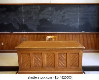 wooden desk and blackboard in school room