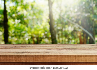 Wooden desk and blurred garden nature bokeh background.