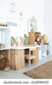 Wooden Desk In Cozy Kid's Room With Toys