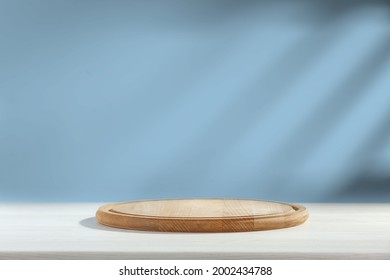 Wooden Desk Of Free Space And Kitchen Board, Blue Wall And Shadows. 