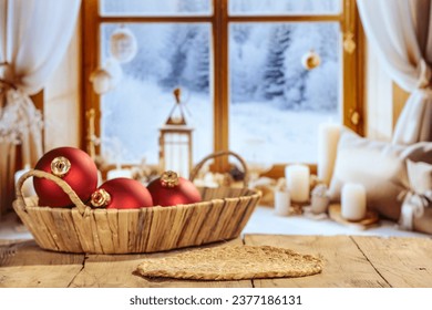 Wooden desk of free space for your decoration and christmas balls. Empty space for your products. Blurred window sill and winter landscape. Christmas time. 