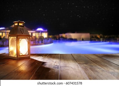 Wooden Desk With Lamp In Hotel Restaurant And Romantic Night 