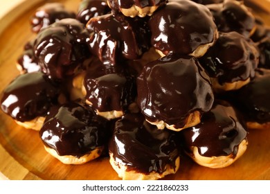 Wooden Dessert Stand With Delicious Eclairs, Closeup