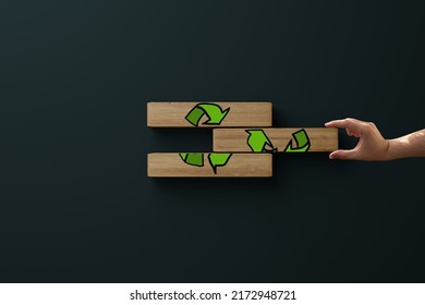 Wooden Dice With A Recycling Icon, Green Arrows With Complement In The Next Cube. The Concept Of Caring For The Environment And Nature.