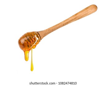 Wooden dipper with honey falling down isolated on a white background.Golden organic honey natural - Powered by Shutterstock