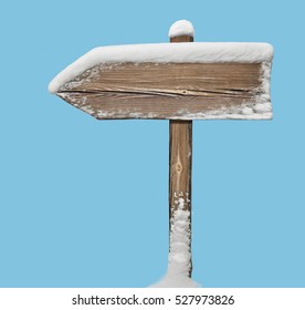 Wooden direction sign with snow on it isolated on blue - Powered by Shutterstock