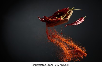 Wooden dish with dried chili pepper and pepper ground. Copy space. - Powered by Shutterstock