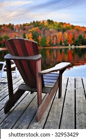 Wooden Dock With Chair On Calm Fall Lake