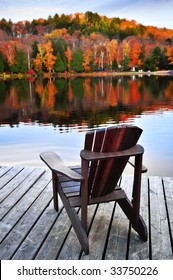 Wooden Dock With Chair On Calm Fall Lake