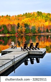 Wooden Dock With Chairs On Calm Fall Lake