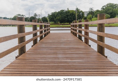 Wooden dock in front of a lake in a public park - Powered by Shutterstock