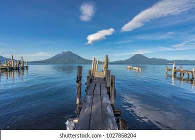 Wooden docks over Lake Atitlan with volcanoes in the background. - Powered by Shutterstock