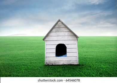 Wooden Doghouse On A Green Meadow