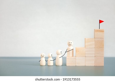 Wooden Doll Family Hold On Together Hiking For Goal On Top Of Wooden Block Steps, Fighting For Success Concept