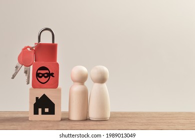 Wooden doll figures with padlock, scammer and home. Real estate scam concept.