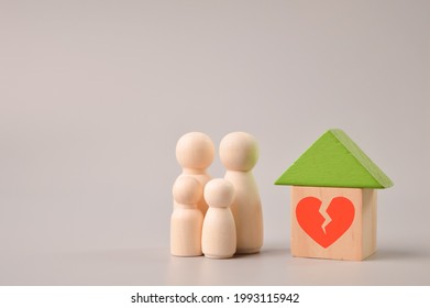 Wooden Doll Figures, Toy House And Broken Heart Symbol. Concept Of Divorce, Family Split And Crack In Relationships.