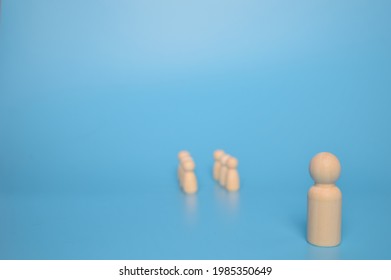 Wooden doll leader stands distantly from the crowd of wooden figures. Leader and leadership concept. - Powered by Shutterstock