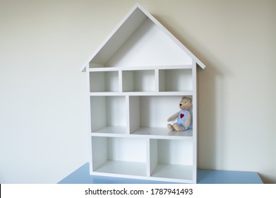 A Wooden Dollhouse With Toy