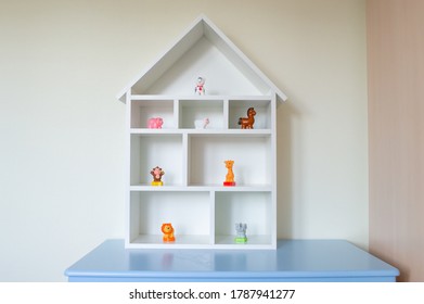 A Wooden Dollhouse With Toys