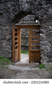 Wooden Door In Ancient Stone Archway