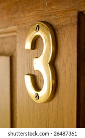 Wooden Door With A Brass Number 3