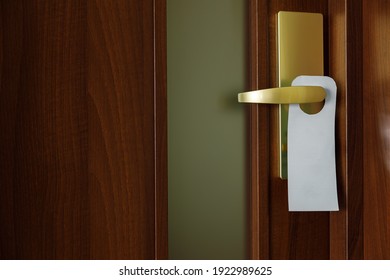 The Wooden Door Is Brown With A Digital Door Lock. Door Hanger Sign With Space For Text.