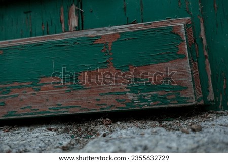 Wooden door and green peeling paint