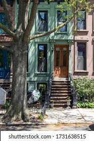 Wooden Door To Green Row Home And Front Stoop In Park Slope, Brooklyn, New York