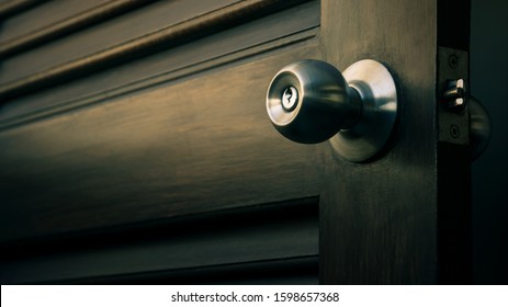 Wooden Door With Grill, Stainless Door Knob Or Handle On Wooden Door In Beautiful Lighting, Dramatic Tone Effect