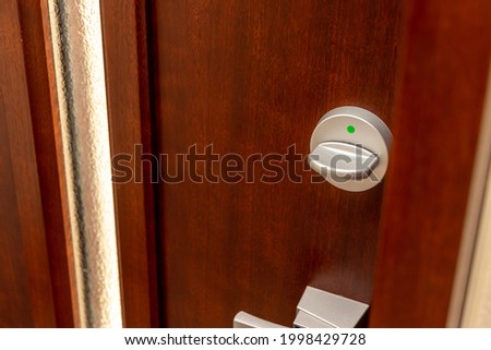 Wooden door with metal thumb turn