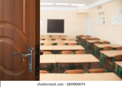 Wooden Door Open Into Modern Empty Classroom