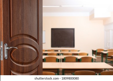 Wooden Door Open Into Modern Empty Classroom