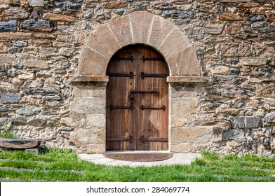 A Wooden Door In A Stone Building In Andorra.