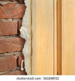 Wooden Door Or Window Install, Closeup Of Polyurethane Foam Wood And Bricks