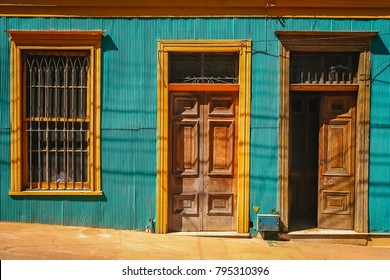 Wooden Doors To Old Tenement House On The Street In Valparaiso, Chile, South America