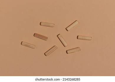 Wooden Dowel Pins On Beige Background.