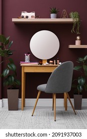 Wooden Dressing Table And Chair Near Brown Wall In Room