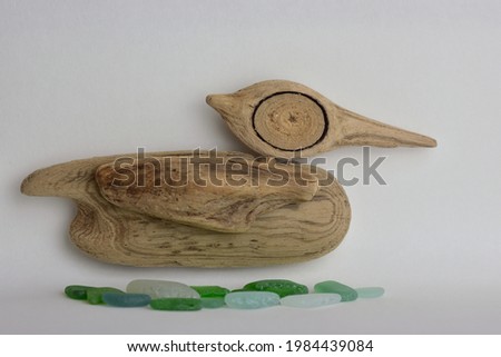 Wooden duck floating on water decoration made of the sea drift wood pieces. Driftwood natural decoration. Driftwood hand made crafts.