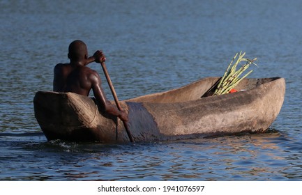 Wooden Dugout Canoe With Man Rowing