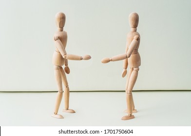 Wooden dummies shaking hands, Cooperation of business - Powered by Shutterstock