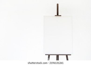 Wooden Easel With Blank Canvas On Light Background For Mockup Design