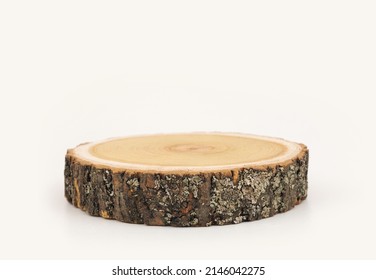 Wooden eco rustic pine tree wood circle disc platform podium on beige background. Minimal empty display product presentation scene.