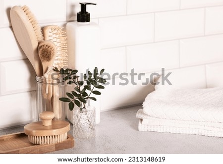Wooden eco-friendly bath accessories and skin care product in the bottle. Bodycare concept. Bathroom interior.