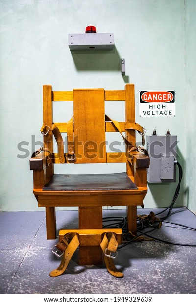 Wooden electric chair for death sentence in\
prison cell concept