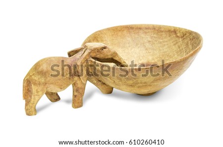 Wooden elephant bowl isolated on the white background. An elephant sits at the edge of the bowl as if to drink from the centre.
