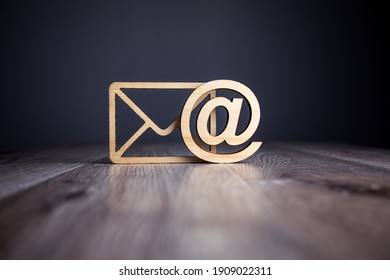 wooden email with letter symbol on table