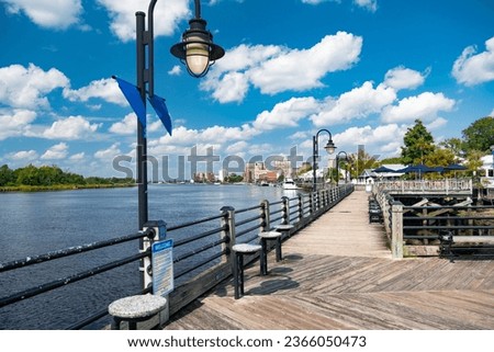 Wooden embankment along the River, Blue sky, snow-white clouds. Wilmington, NC